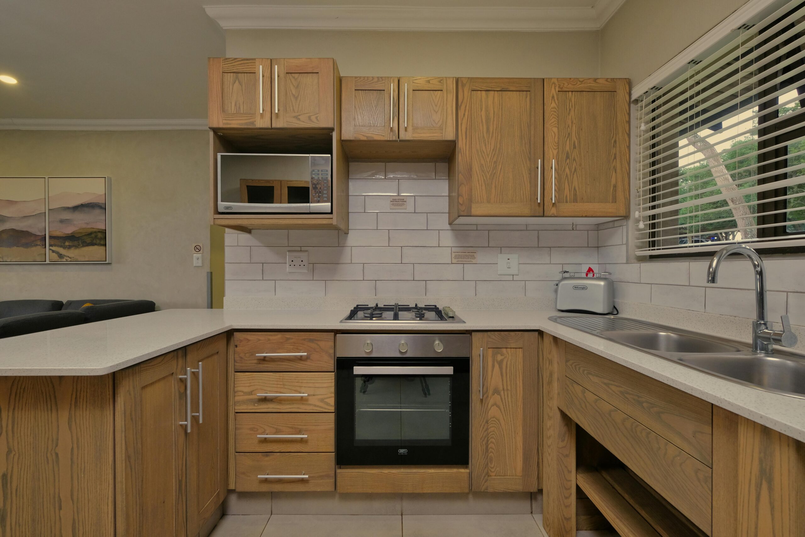 flat in mumbai Contemporary wooden kitchen with built-in appliances and stylish decor.